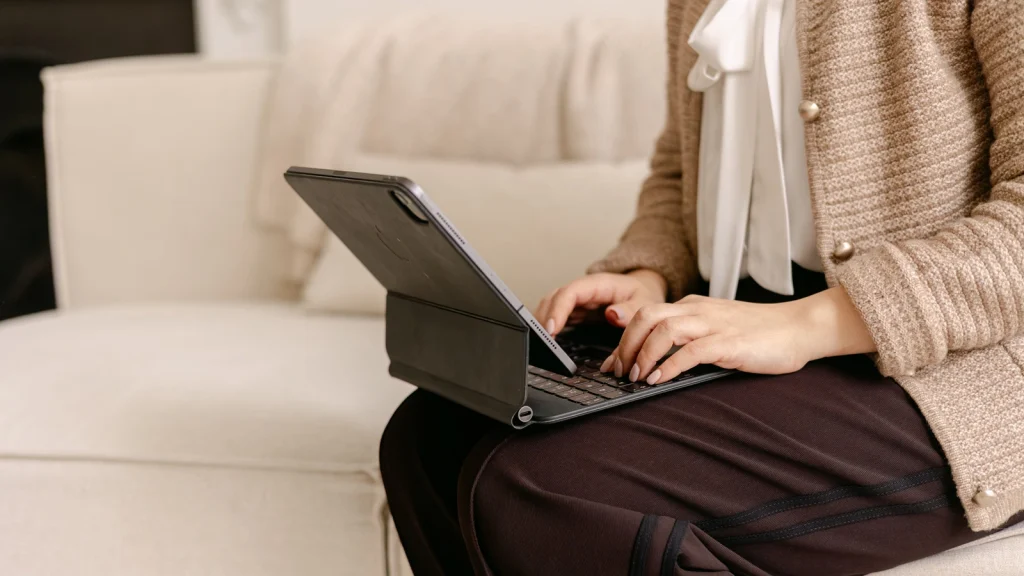 Dr Fatima using a tablet at Bashra Aesthetics while managing patient appointments.